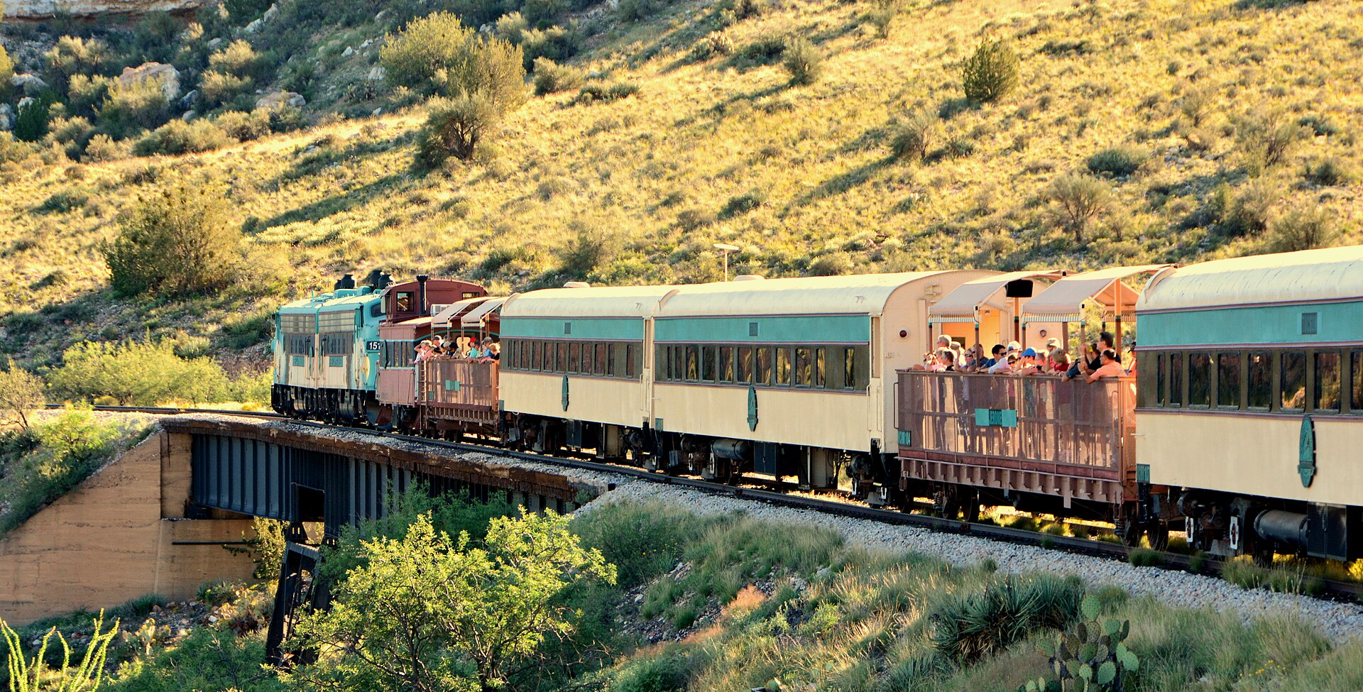 Verde Canyon Railroad train and open-air viewing cars crossing the Verde Valley landscape near Clarkdale